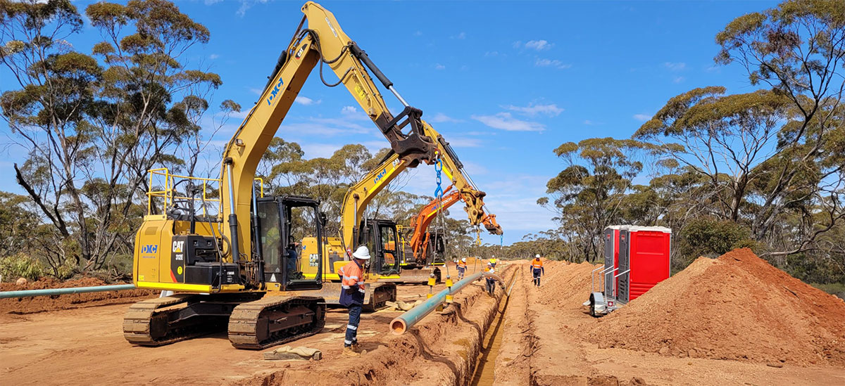 Hitachi excavator and dump truck at mining site — CC,C&M Division